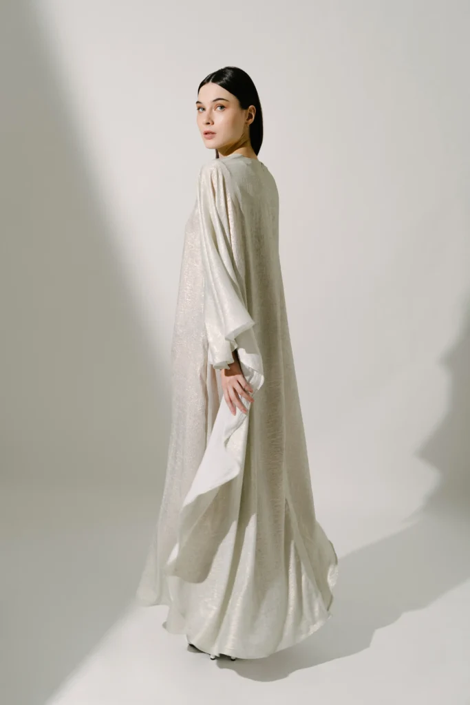 a woman wearing luxurious modest fashion dress by Demure & CO